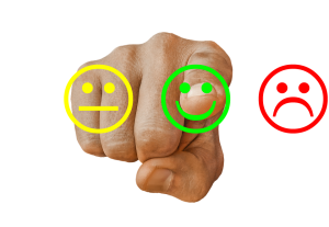 Photo of finger point at good, poor, and neutral emojis