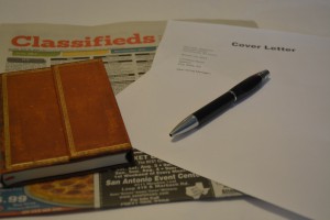 Photo of cover letter and classifieds section of newspaper
